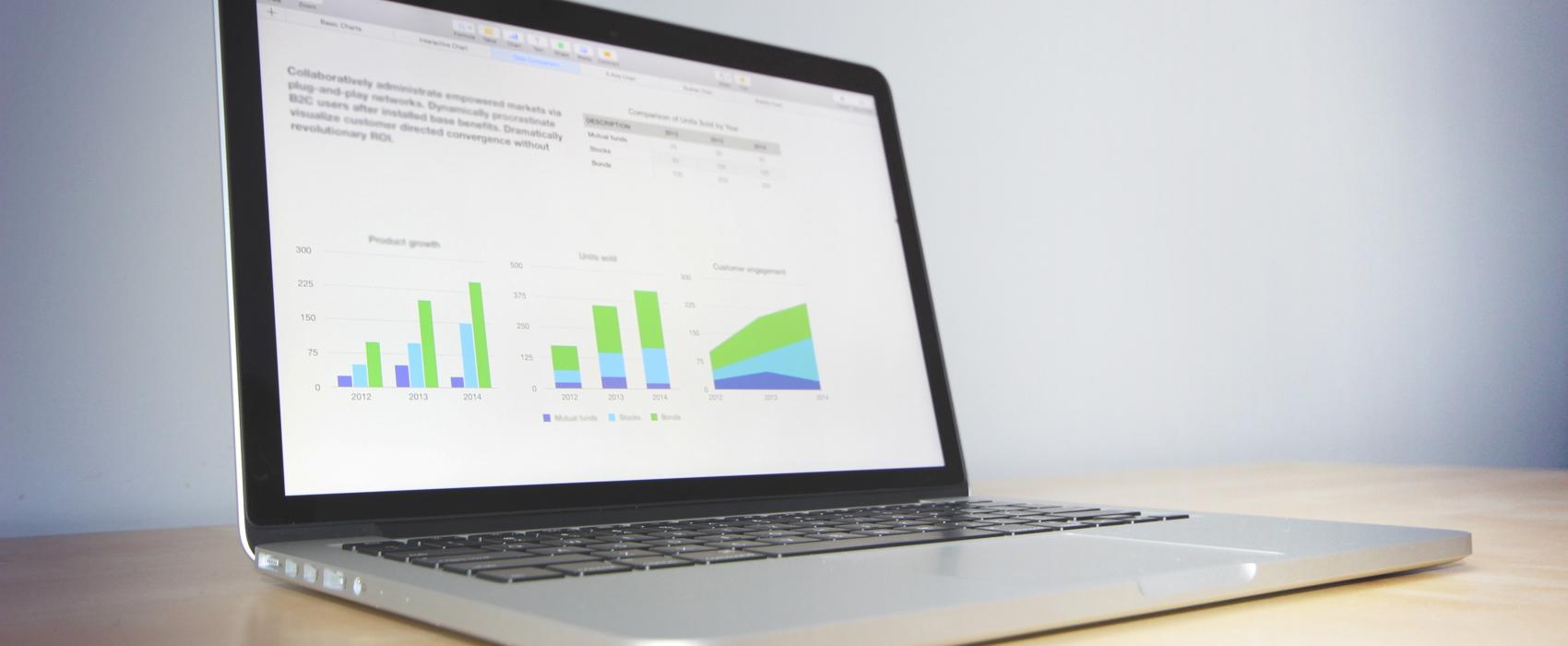 laptop with charts on the screen