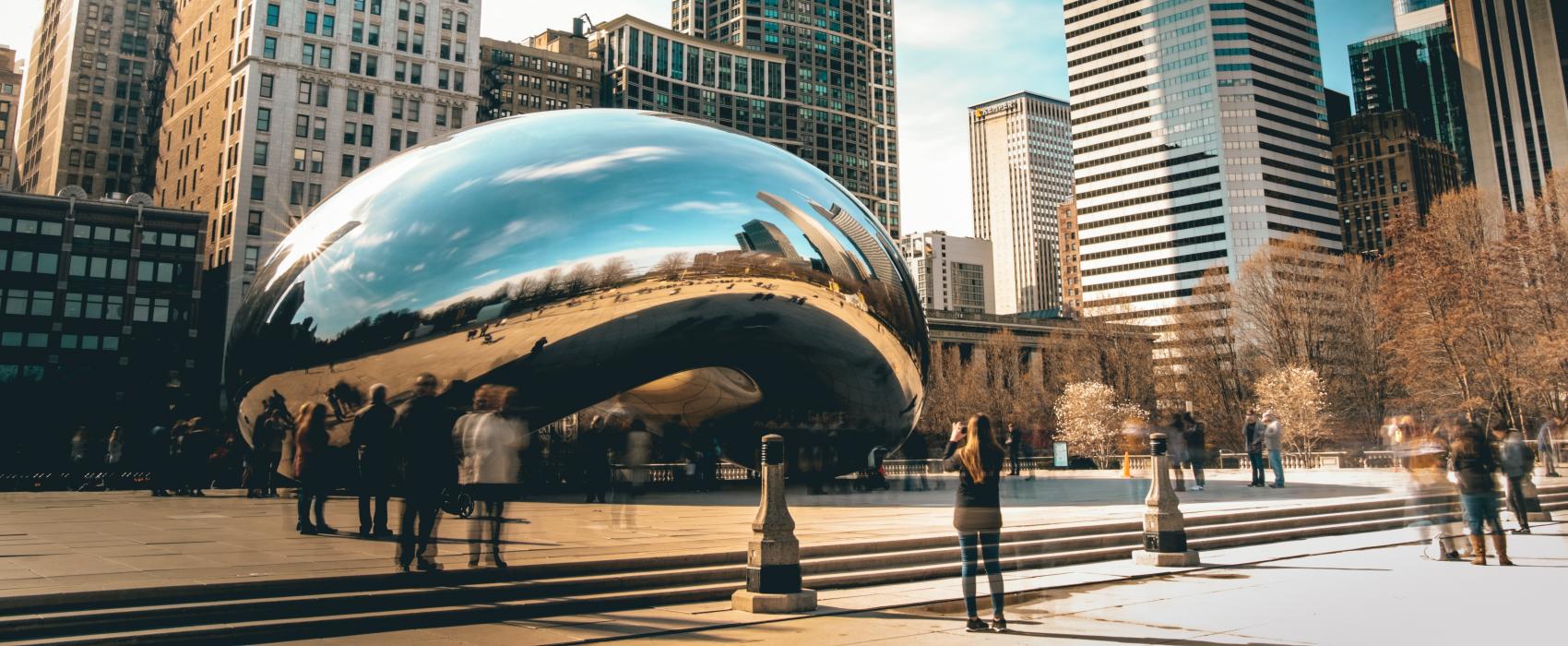 A view of the Chicago skyline from Millenium Park with the silver "bean" in the foreground